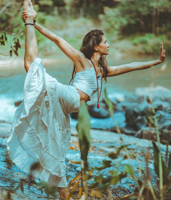 Person practicing yoga outdoors, showing strength and flexibility in nature.